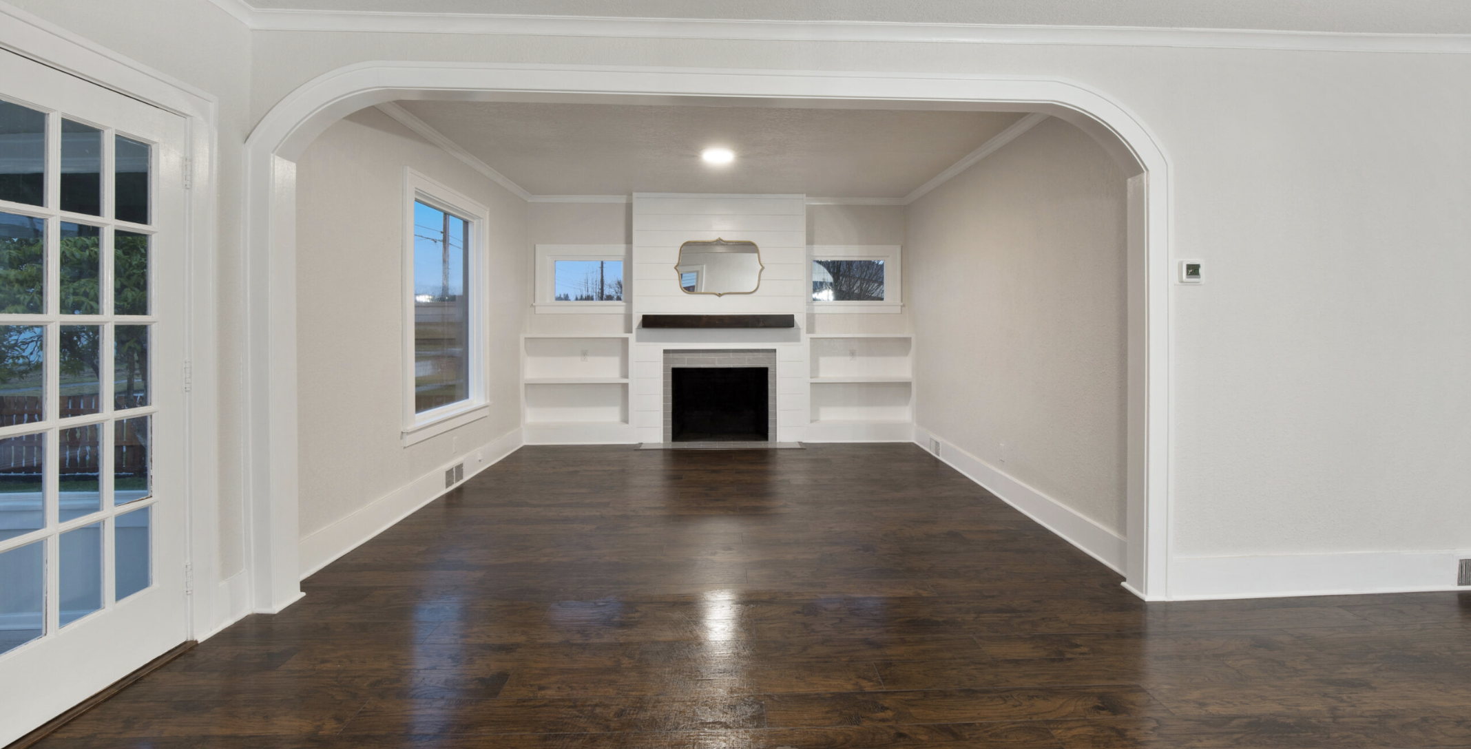3rd St Cosmopolis — living room with arched entry and shiplap fireplace