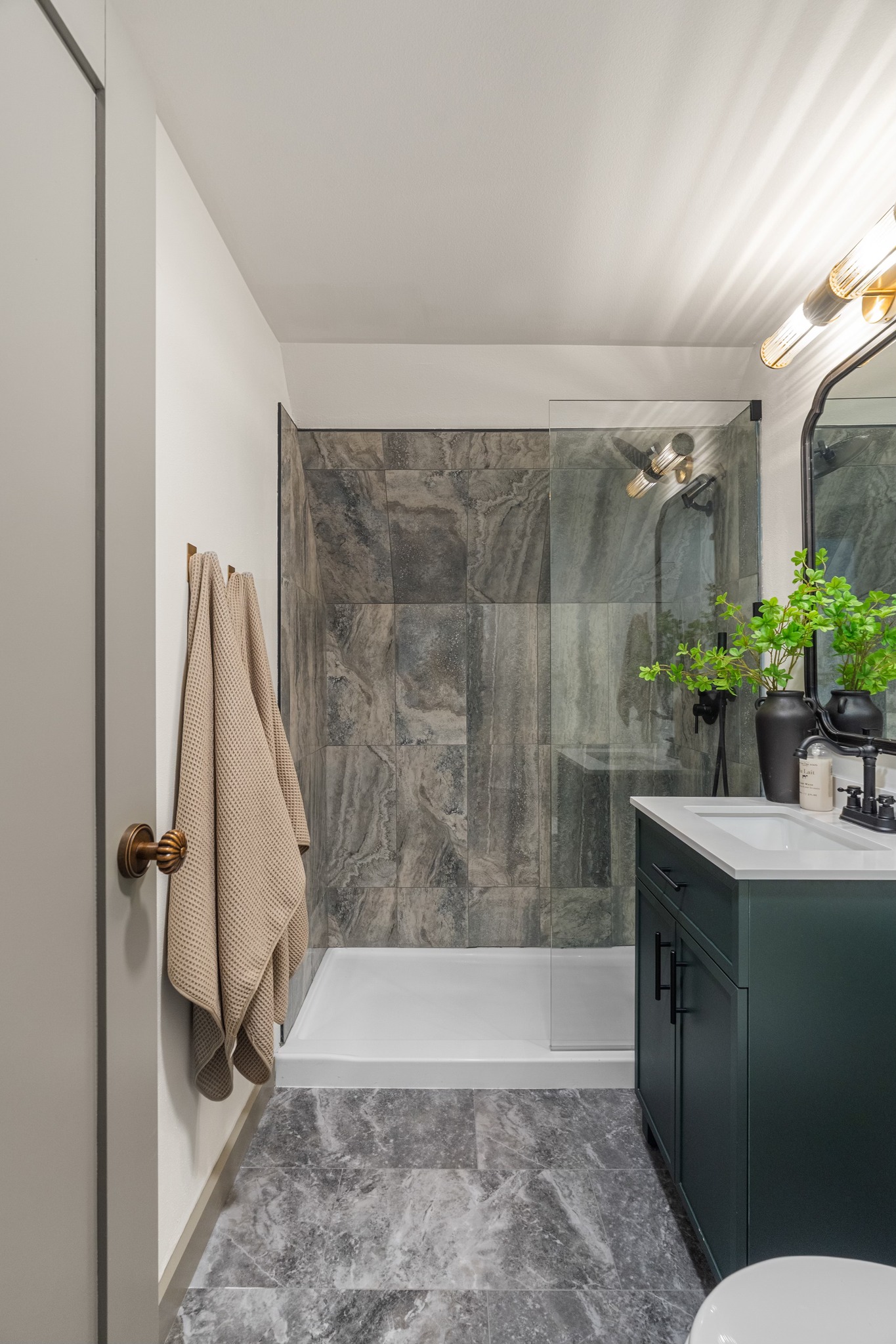 Eklund Ave — bath with marble-look tile and green vanity