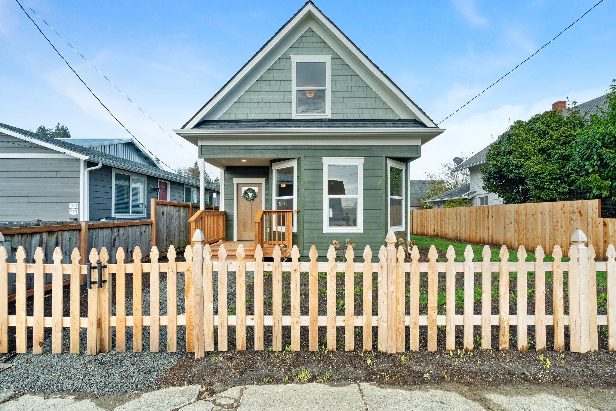 Eklund Ave — restored green Victorian cottage with picket fence