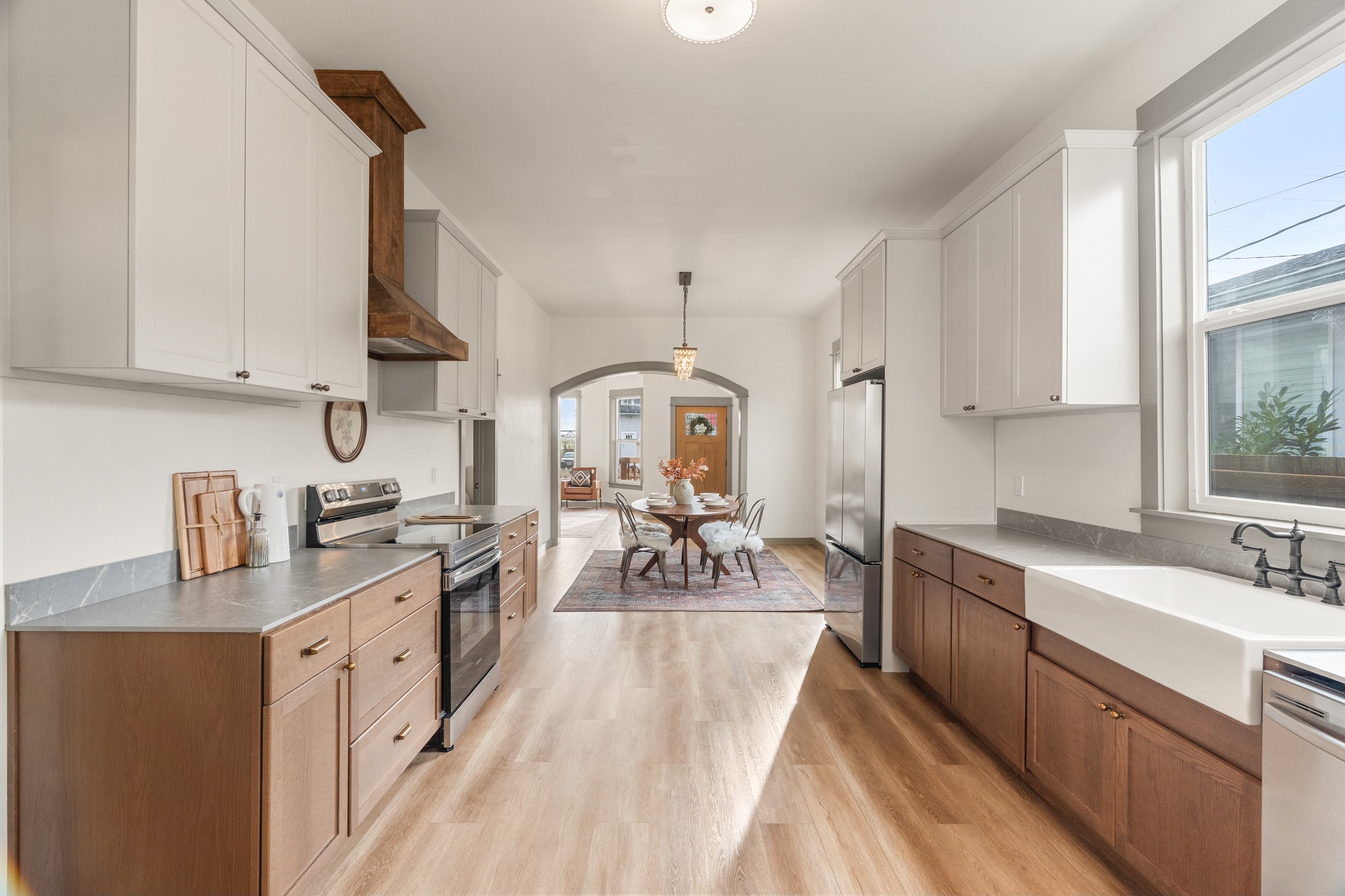 Eklund Ave — kitchen open to dining with wood range hood