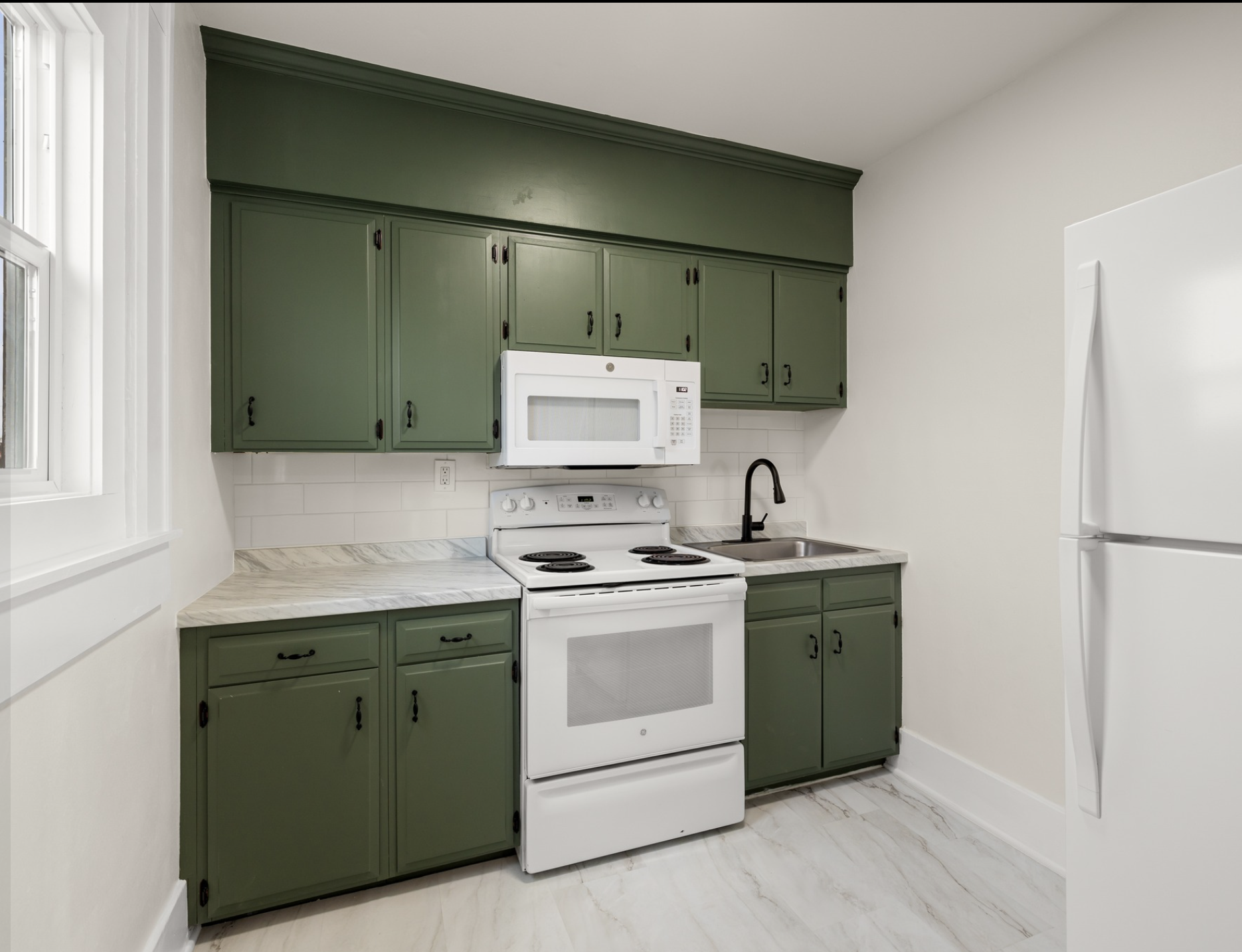 Mayflower Apartments — living room with coffered ceiling, view through to green kitchen
