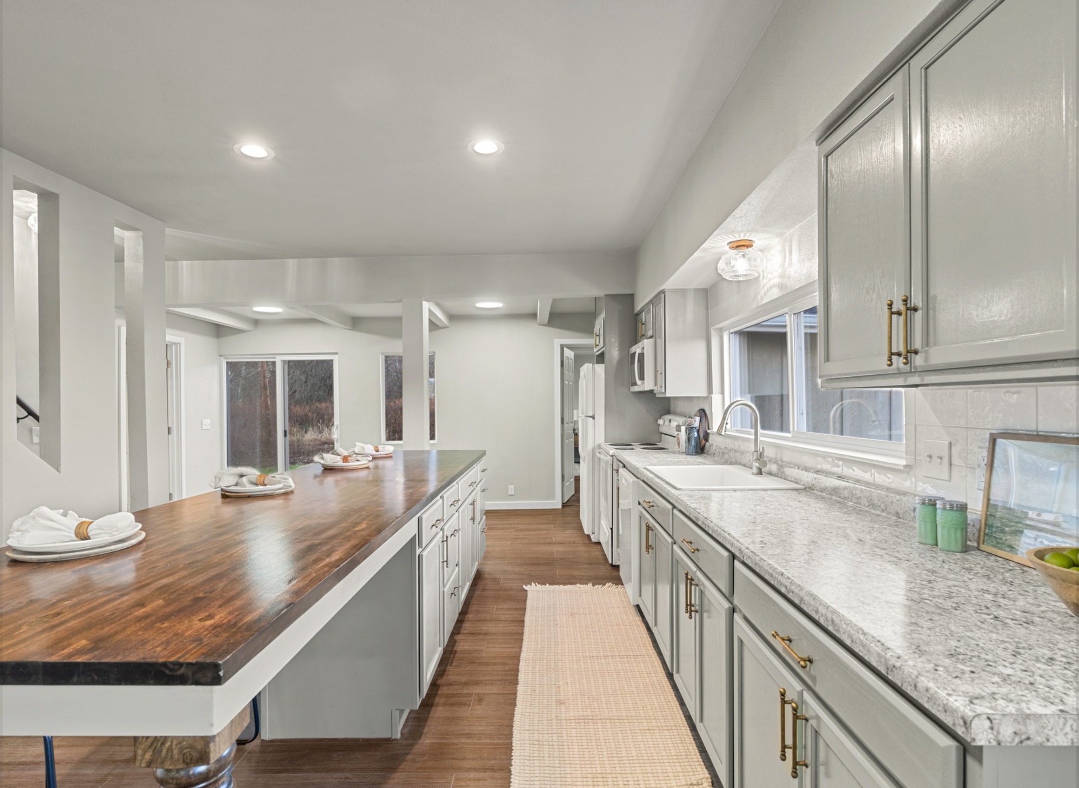 S W Blvd — galley kitchen with butcher block and granite
