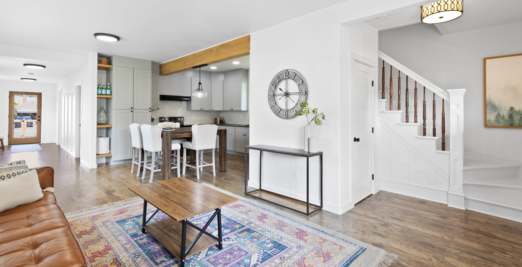 W 2nd St — main floor: open kitchen, dining, living, and staircase