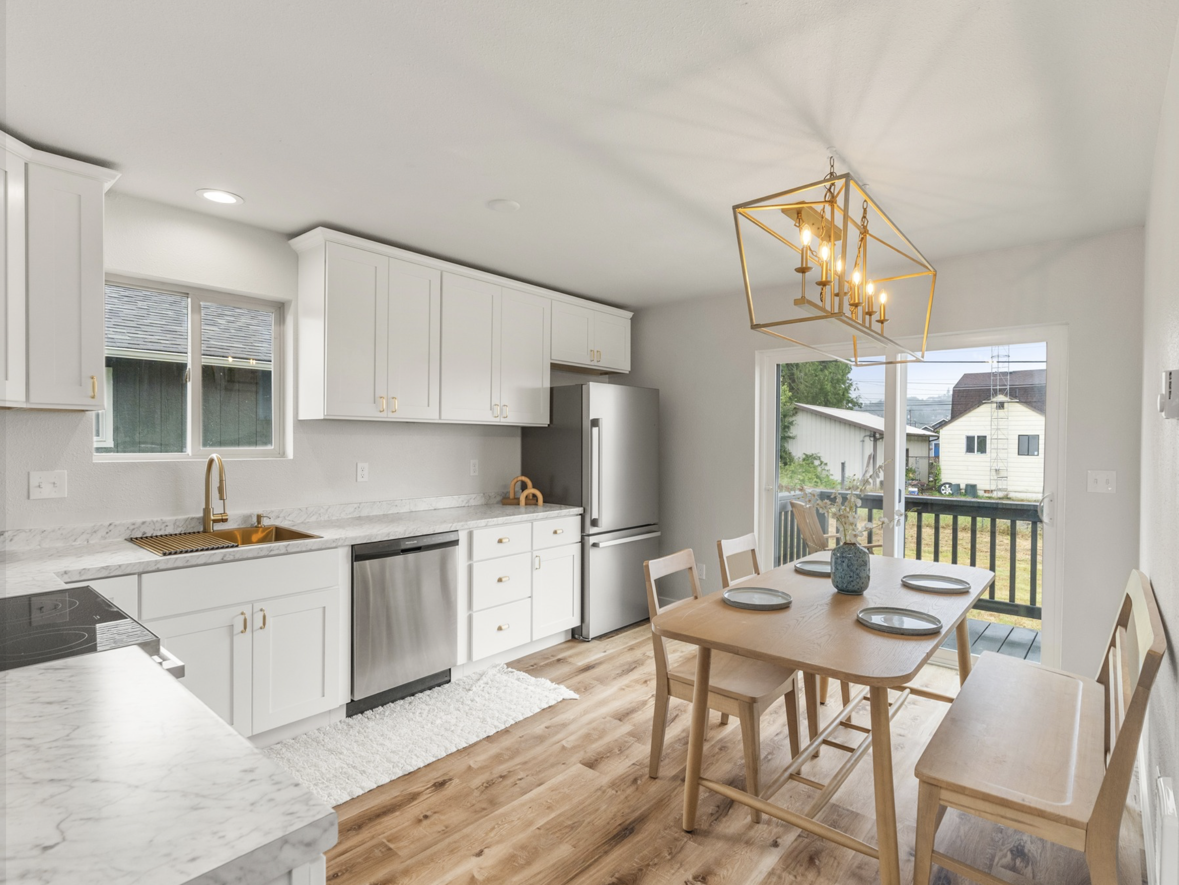 Market St — white kitchen with brass fixtures and dining nook