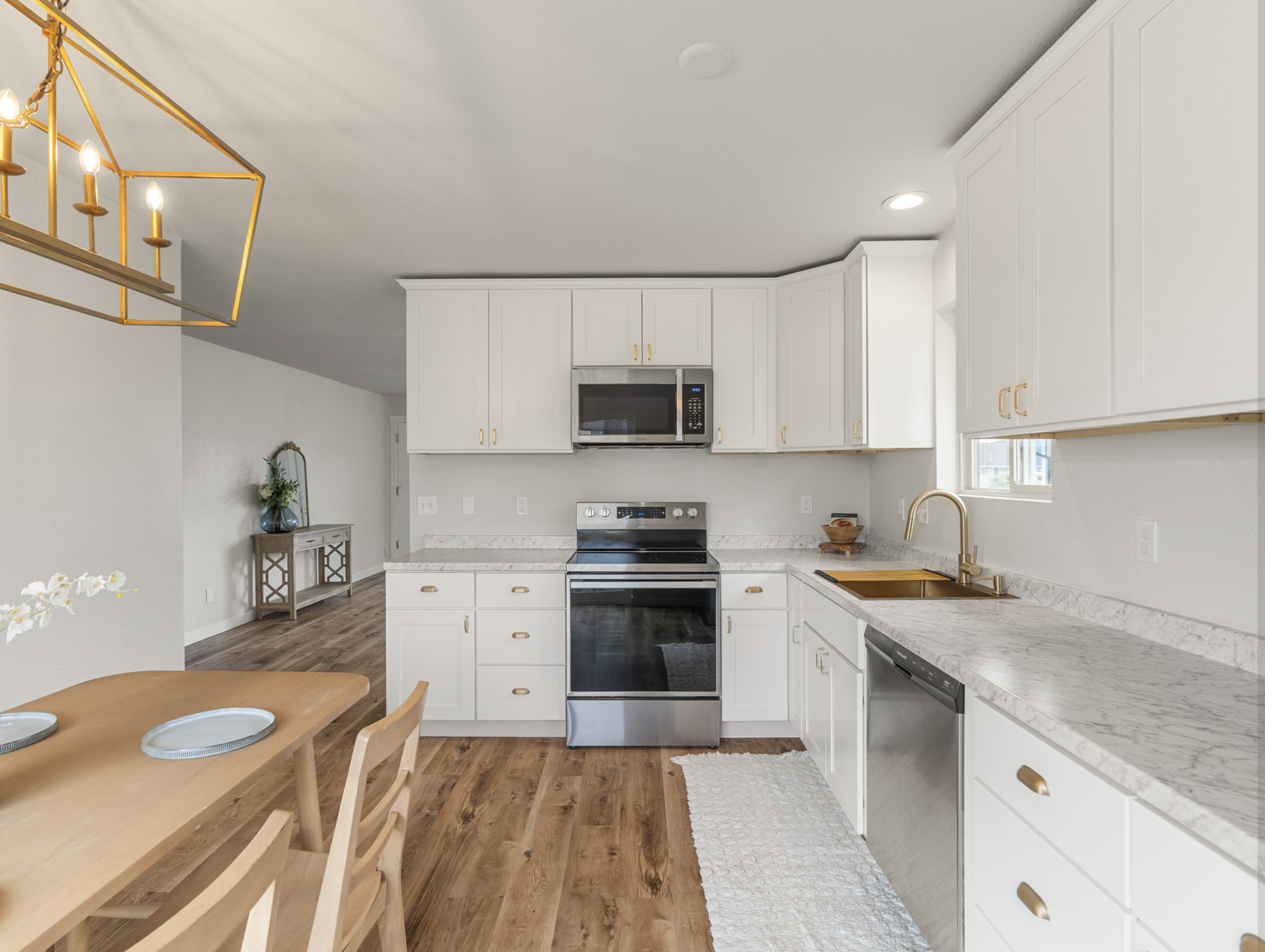 Market St — kitchen with white cabinets and gold pendants