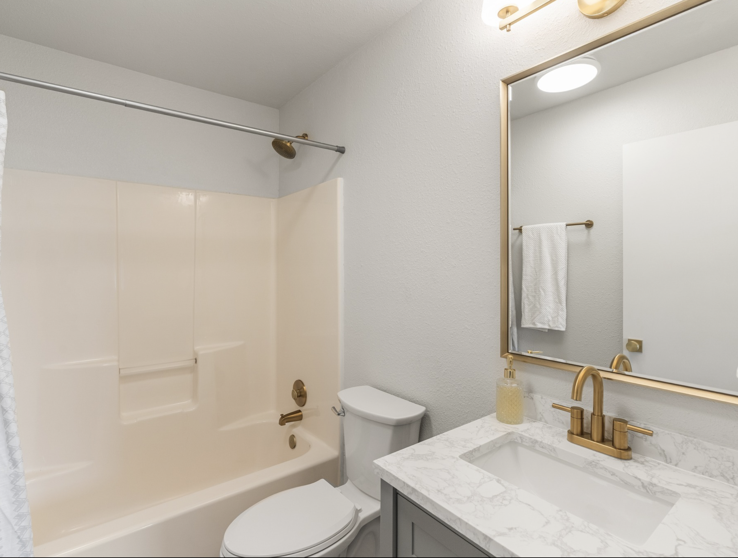 Market St — guest bath with brass fixtures
