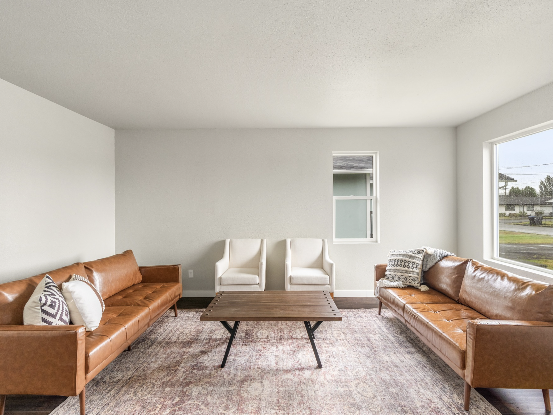 W Market St — living room with leather sofas