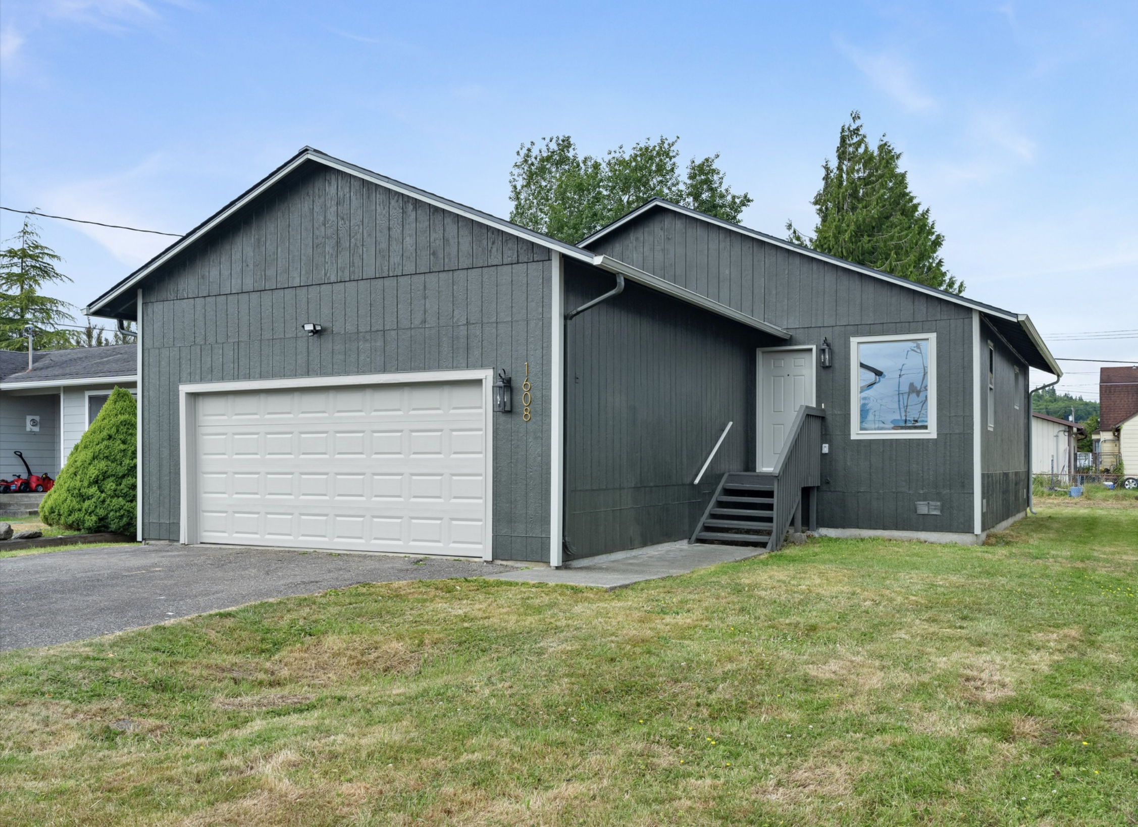 W Market St — dark gray board-and-batten ranch exterior